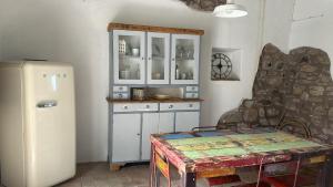 a kitchen with a refrigerator and a table in a room at Ca di Rosa in Aulla