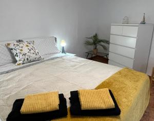 a bedroom with a bed with two towels on it at Coastine Granada - Casa con vistas al mar en Castell de Ferro in Castell de Ferro