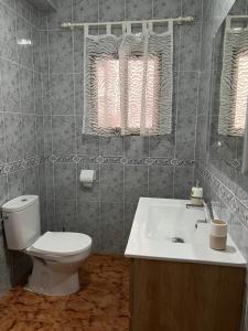 a bathroom with a toilet and a sink at Coastine Granada - Casa con vistas al mar en Castell de Ferro in Castell de Ferro +6 photos