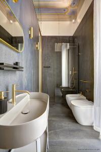 a bathroom with three sinks and two toilets at Piccapane Rooms 1886 in Barletta