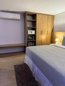 a bedroom with a large bed and a tv at Apartamento no Hotel Radisson Belém in Belém +19 photos