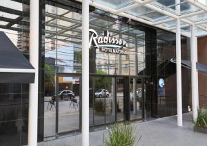 a building with a sign on the front of it at Apartamento no Hotel Radisson Belém in Belém
