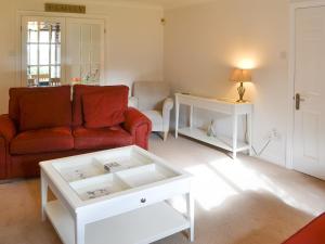 a living room with a couch and a coffee table at Hawthorne House in Amble
