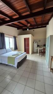 a large bedroom with a bed and a kitchen at Hotel Fênix in Florianópolis +28 photos