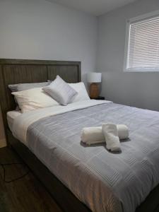 a bed with two towels on top of it at Springfield Kensington in Saskatoon +28 photos
