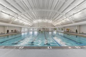 a large indoor swimming pool with a large ceiling at Beachaholic in Corolla