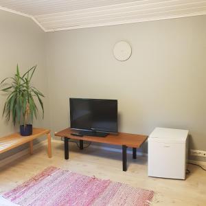 a living room with a television on a table at Ahopelto in Savonlinna