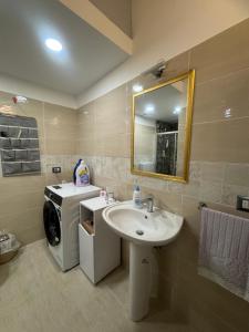 a bathroom with a sink and a washing machine at La notte dei tempi in Scaletta Zanclea +85 photos