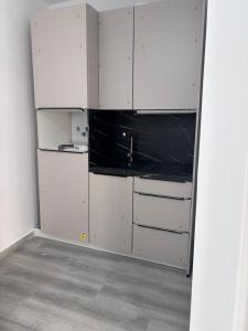 eine Küche mit weißen Schränken und einer schwarzen Arbeitsplatte in der Unterkunft excelente estudio a 200 metros playa in Marbella
