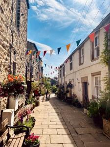 an alley with flags and flowers on a street at The Old Middle School Addingham in Addingham