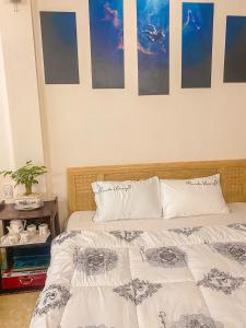 a bedroom with two beds and a table at Nhà Của Mai in Mộc Châu