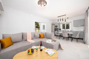 a living room with a gray couch and a table at Villa Tania Dio in Karavádhos