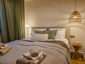 a bedroom with a large bed with towels on it at Haus Kleinod in Bodensdorf