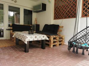 a patio with a table and a couch and a chair at U Julii 2 in Okuninka