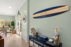 a living room with a boat hanging on the wall at Aloha Shores in Southern Shores +74 photos
