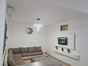 Raʼs al JabalRAS JEBEL APT route de la plage vue sur mer的带沙发和电视的白色客厅