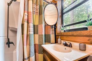 a bathroom with a sink and a mirror at Covered Wagon Vacation Rental in Broken Bow! in Broken Bow +16 photos