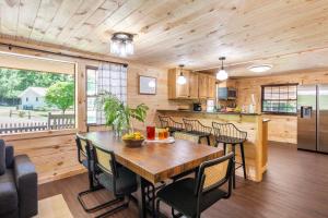 a kitchen and dining room with a table and chairs at 2 Mi to Dtwn Spacious Gatlinburg Home with Hot Tub! in Gatlinburg