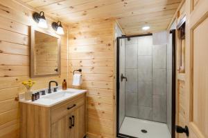 a bathroom with a sink and a shower at 2 Mi to Dtwn Spacious Gatlinburg Home with Hot Tub! in Gatlinburg +36 photos