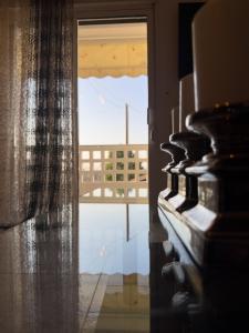 a room with a window with a view of a balcony at Erra Stay in Perea