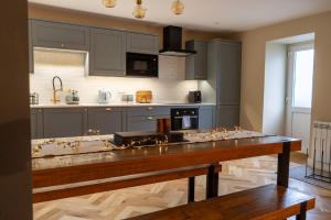a kitchen with a wooden table and a counter top at No4 Invereoch in Arrochar