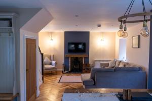 a living room with a blue couch and a tv at No4 Invereoch in Arrochar
