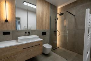 a bathroom with a sink and a shower at Vidalis Suites in Cluj-Napoca +33 photos