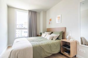 a bedroom with a large bed and a window at Bext Valdebebas in Madrid +33 photos