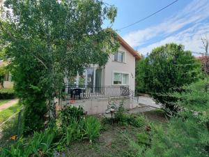 a white house with a porch and a tree at Relax & Spa-House near Therma Numera in Burgas City