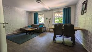a living room with a table and a couch at FeWo Ertel in Hennigsdorf