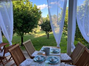 a table and chairs on a patio at B&B Medali in Vernole