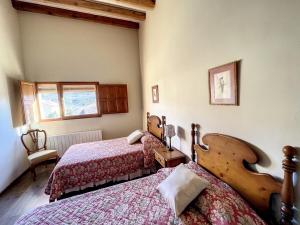 a bedroom with two beds and a window at SINES housing in Casla in Casla