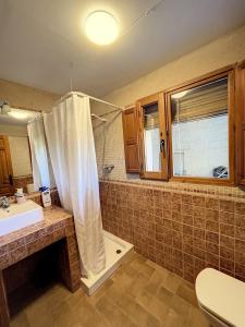 a bathroom with a shower and a sink and a tub at SINES housing in Casla in Casla +16 photos
