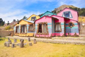 a group of houses painted in different colors at Cabañas sumasamawi in La Playa Bejarano
