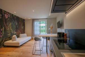 a kitchen with a couch and a table in a room at Villa Amelia in Orta San Giulio