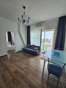 VăleniにあるBlue Sky Apartmentのソファとテーブルのあるリビングルーム