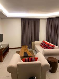 a living room with two couches and a table at Luxuary 1 Bedroom Apartment Pool and Sea view in Dauin in Dauin
