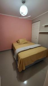 a bedroom with a bed and a light on the ceiling at Comfortable New Family House in Manta +15 photos