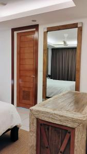 a bedroom with a bed and a large mirror at Luxuary 1 Bedroom Apartment Pool and Sea view in Dauin in Dauin +15 photos