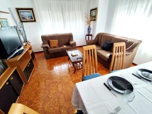 a living room with two couches and a television at Airtegal Litoral 49 Cedeira in Cedeira