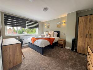 a bedroom with a bed and a window at Large House Near Racecourse, City & Uni in Henwick