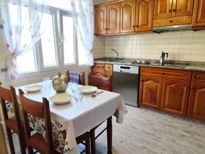 a kitchen with a table with a white table cloth on it at Airtegal Litoral 49 Cedeira in Cedeira