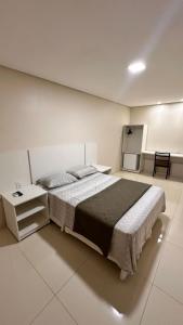 a bedroom with a large bed and a table at Hotel Rancho Verde in Barreiras +35 photos