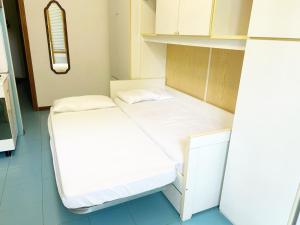 a small room with two beds in it at Casa Splash a Marina di Cecina by Zoom In Earth in Marina di Cecina