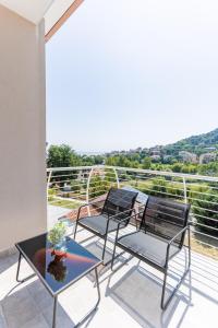 a patio with chairs and a table on a balcony at Luxury Seaside Escape - Coralia in Marina San Vito
