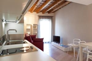 a kitchen and living room with a sink and a couch at Residenza Madonna Verona in Verona