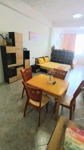 a living room with a table and chairs and a bed at Sani Family Hotel in Byala +23 photos