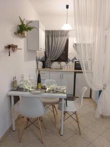 a kitchen with a table and chairs in a kitchen at Adelia's Luxury Studio in Corfu in Corfu