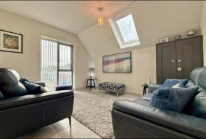 a living room with two couches and a window at Stylish apartment in Portstewart in Moffat