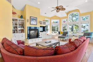 a living room with a couch and a fireplace at Animal House in Corolla